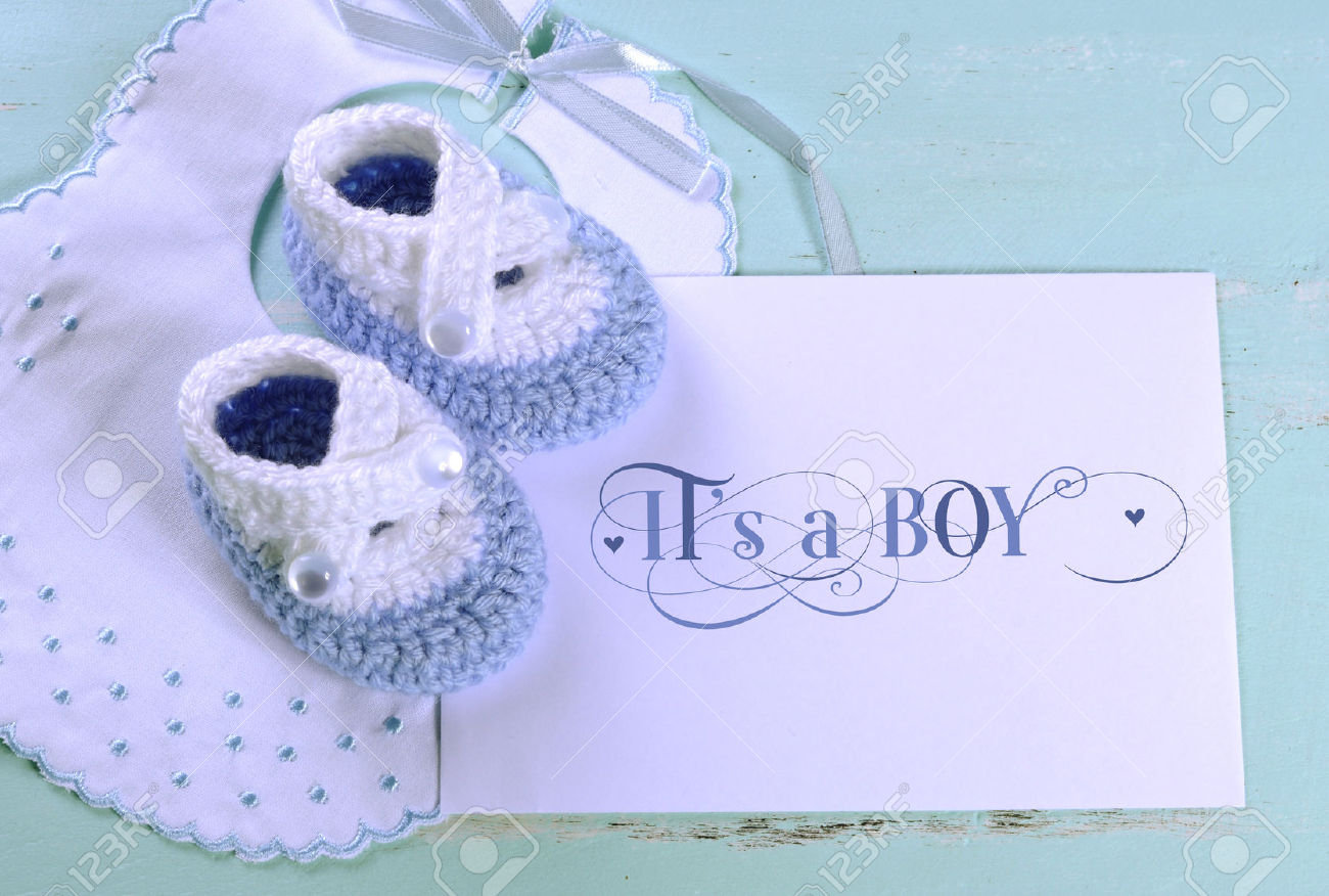 28242924-Baby-boy-nursery-blue-and-white-wool-booties-bib-and-card-with--Stock-Photo